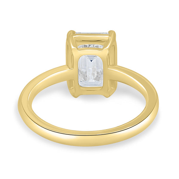 Close-up of emerald cut lab grown diamond solitaire engagement ring highlighting the secure bezel setting and step-cut facets