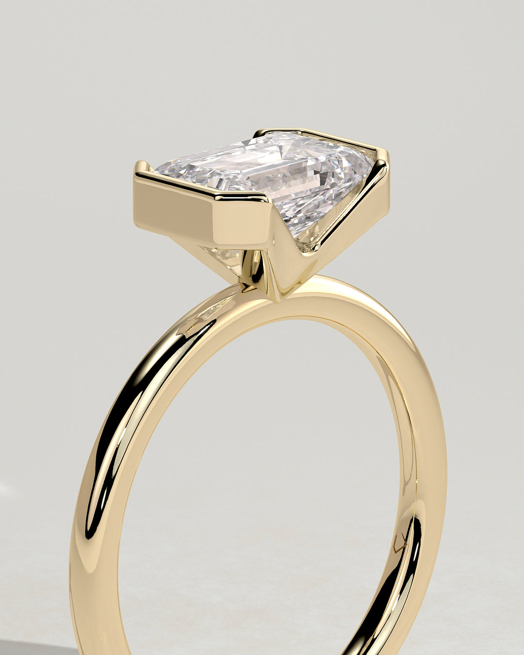 Emerald Cut East West Half Bezel Solitaire Engagement Ring