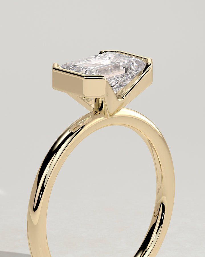 Emerald Cut East West Half Bezel Solitaire Engagement Ring