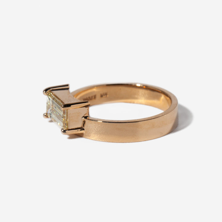 Side profile of east west emerald cut lab grown diamond monolith engagement ring with sleek modern structure