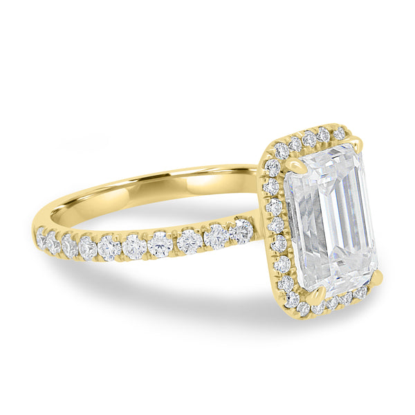 Side profile of emerald cut lab diamond halo pavé engagement ring showing delicate pavé band and elevated center stone