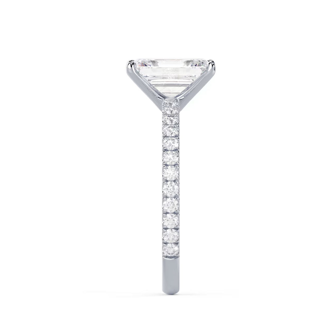 Side profile of an emerald cut lab grown diamond pave engagement ring showing slim elegant band structure