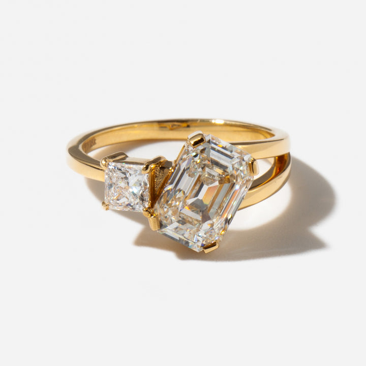 Close-up of emerald and princess cut lab diamond Toi Et Moi ring showing contrasting shapes and modern pairing
