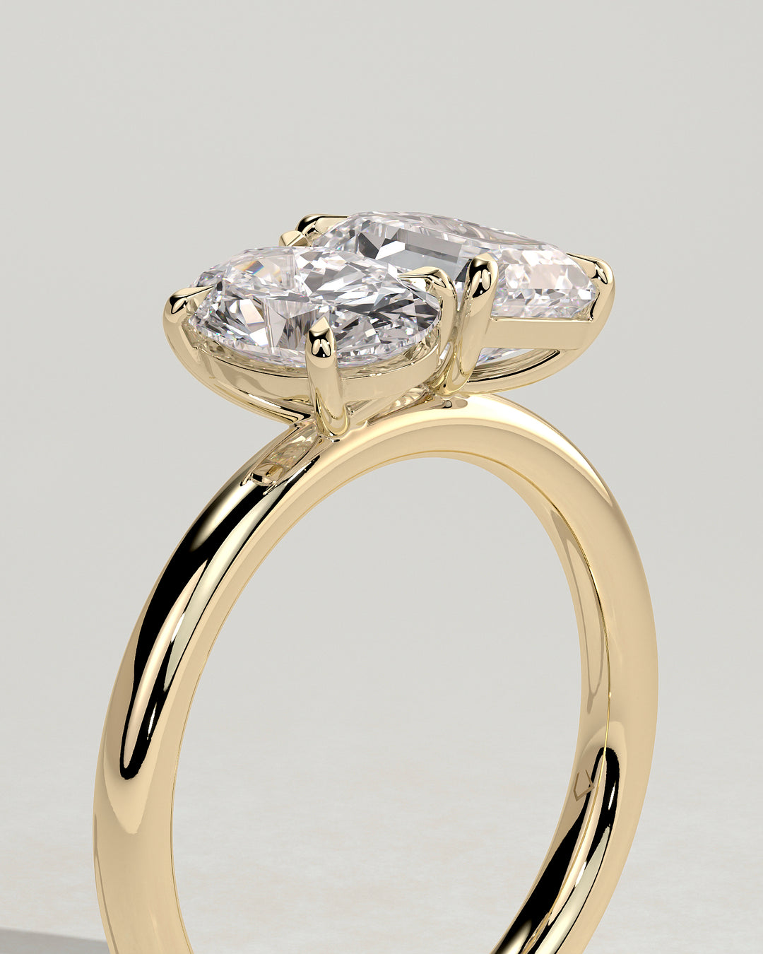 Emerald cut and oval diamond ring