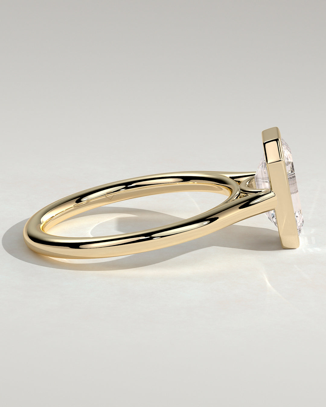 Emerald cut bezel solitaire