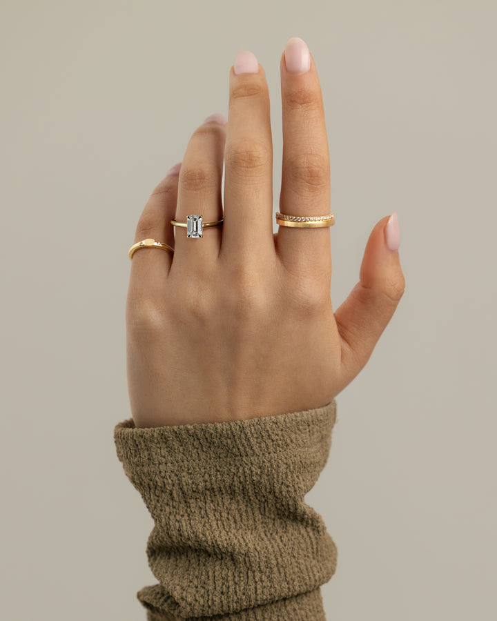 Emerald hidden halo diamond ring