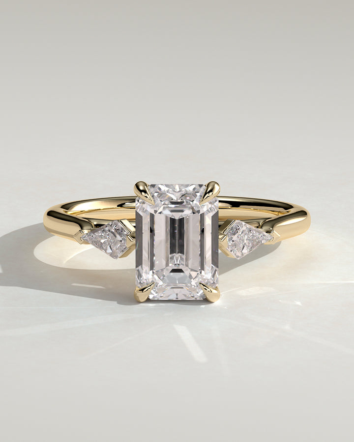Emerald trilogy engagement ring