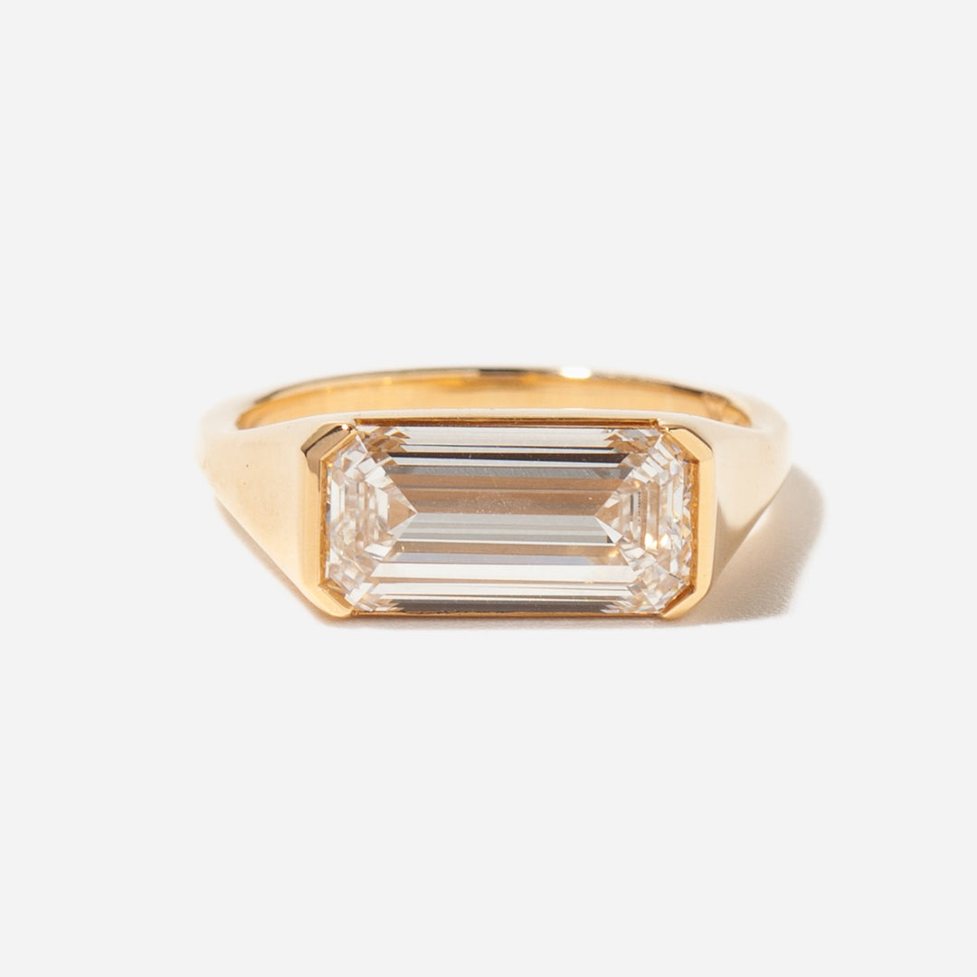 Side profile of horizontal emerald cut lab diamond solitaire signet ring with elevated architectural setting design