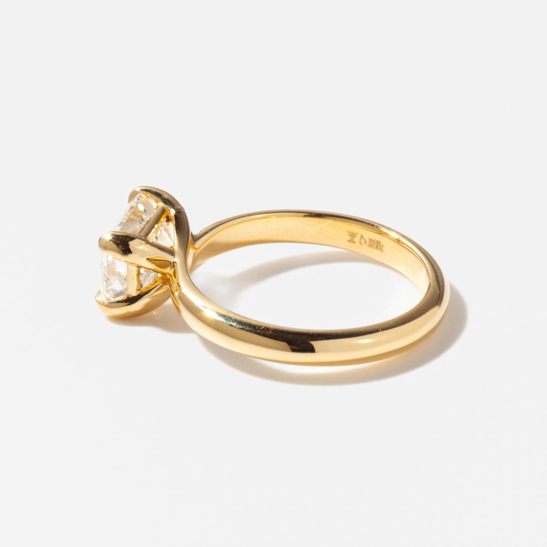 Side profile of horizontal emerald cut lab diamond engagement ring highlighting sleek solitaire setting and low profile design