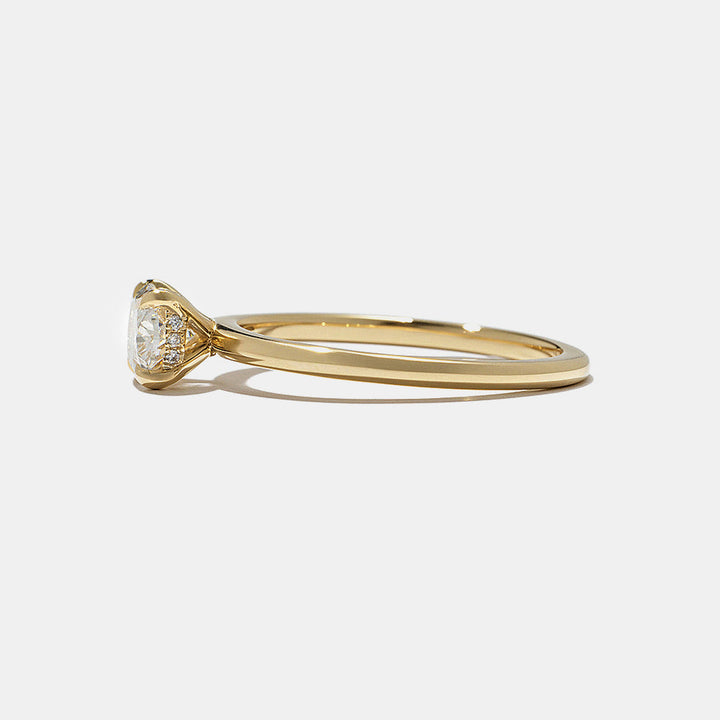 Side profile of horizontal oval lab diamond hidden halo engagement ring featuring sleek modern solitaire structure