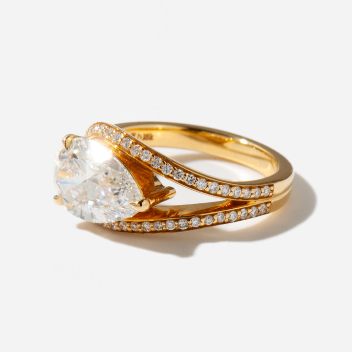 Close-up of an east west pear cut lab grown diamond engagement ring highlighting unique horizontal orientation and brilliance