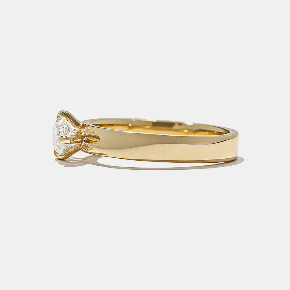 Side profile of marquise east west lab diamond cigar band solitaire engagement ring highlighting bold structure and secure setting