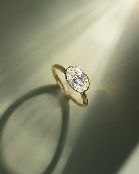 Minimalist oval E VS1 lab diamond engagement ring with horizontal layout and refined contemporary design