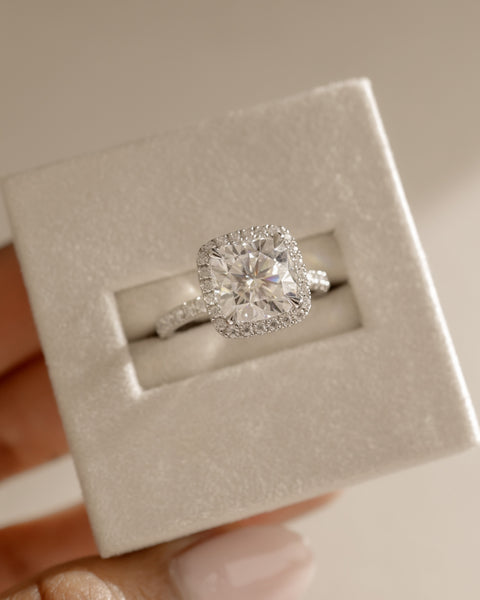 Modern cushion lab diamond halo pavé engagement ring featuring sparkling side stones and elegant symmetrical design