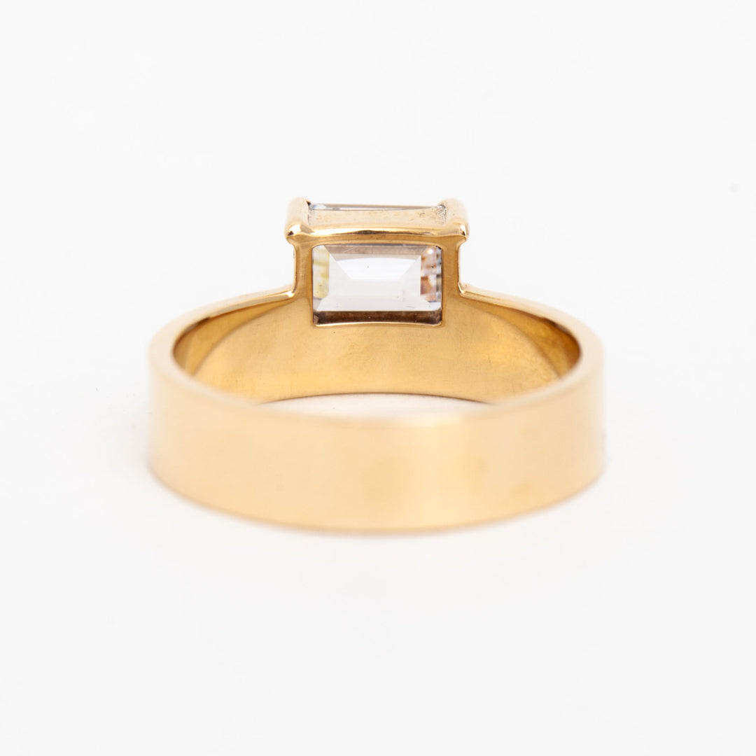 Modern east west emerald cut lab grown diamond monolith engagement ring featuring clean geometric architectural styling