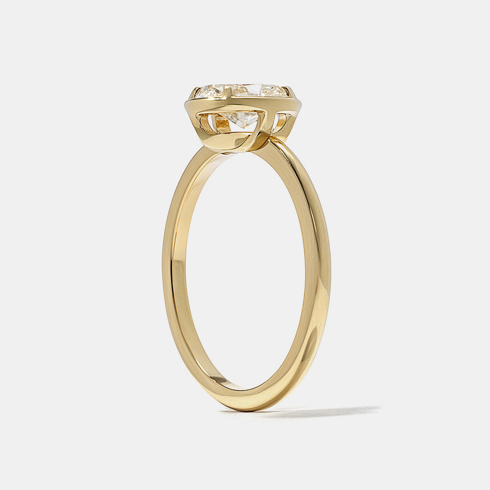 Modern oval lab grown diamond bezel engagement ring designed with minimalist solitaire aesthetic and clean lines