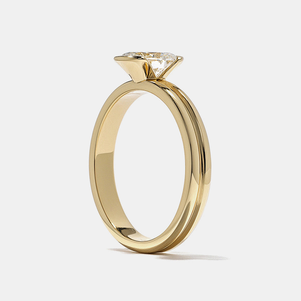 Modern oval lab grown diamond half bezel solitaire engagement ring designed with sleek open side structure