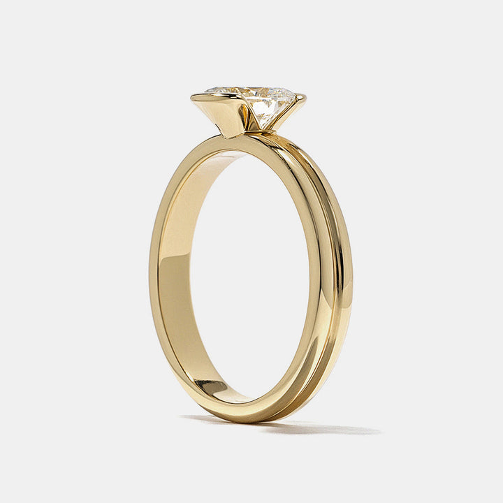 Modern oval lab grown diamond half bezel solitaire engagement ring designed with sleek open side structure