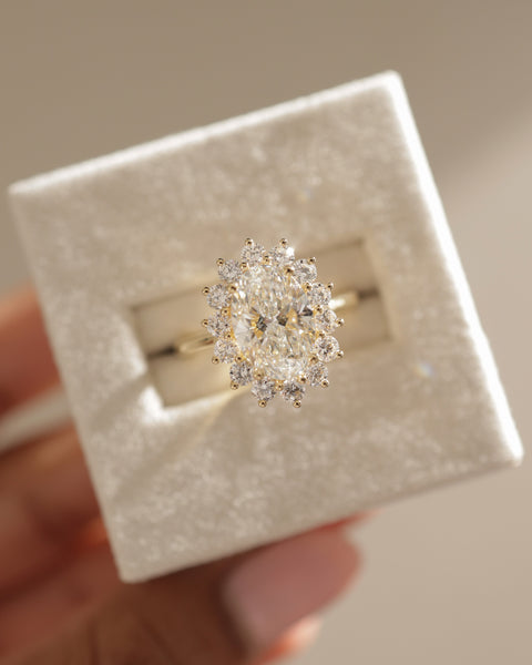 Modern oval lab diamond halo cathedral engagement ring featuring elevated center stone and sparkling halo accent design