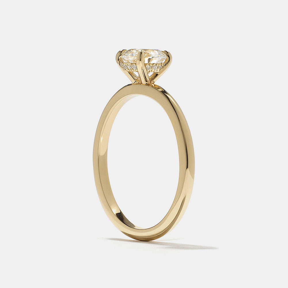 Modern round lab grown diamond engagement ring featuring hidden halo solitaire design set in polished gold band