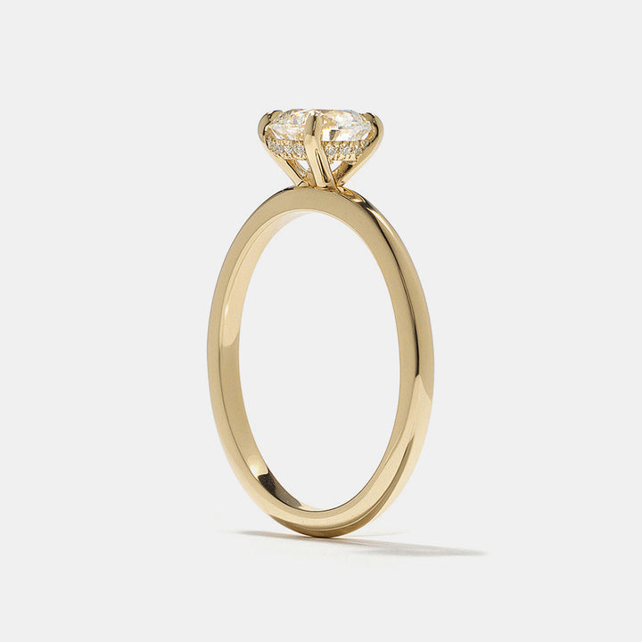 Modern round lab grown diamond engagement ring featuring hidden halo solitaire design set in polished gold band