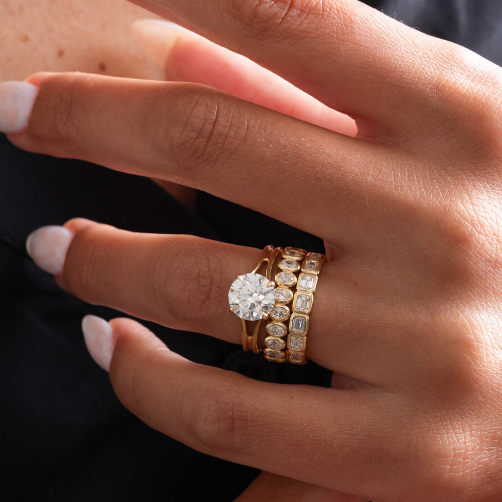 Modern bridal ring featuring a round lab grown diamond and a refined split shank engagement setting