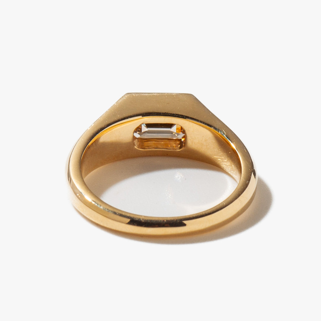 Modern signet engagement ring featuring east west emerald cut lab grown diamond in minimalist solitaire design