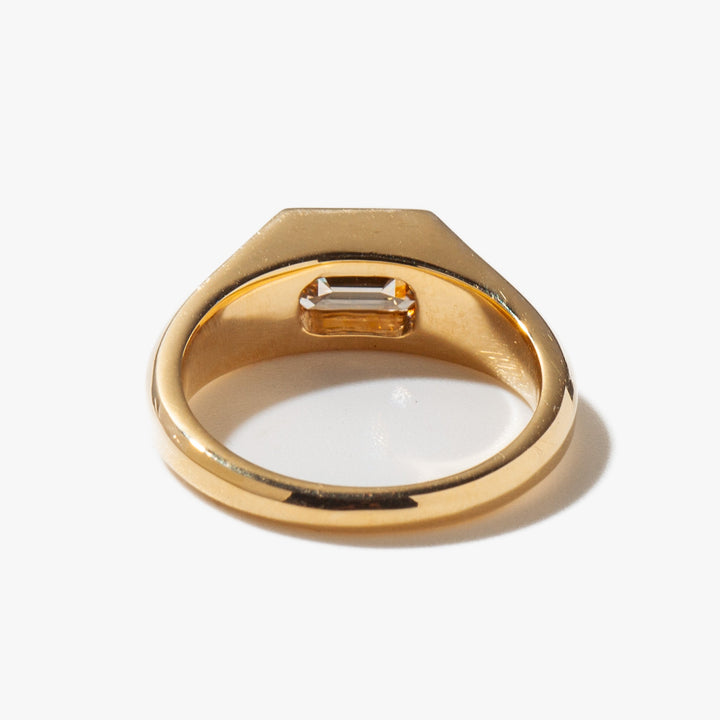 Modern signet engagement ring featuring east west emerald cut lab grown diamond in minimalist solitaire design
