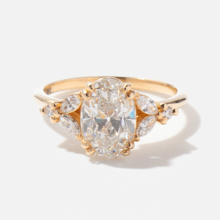 Close-up of oval lab grown diamond cluster engagement ring showing multi-stone brilliance and refined setting craftsmanship
