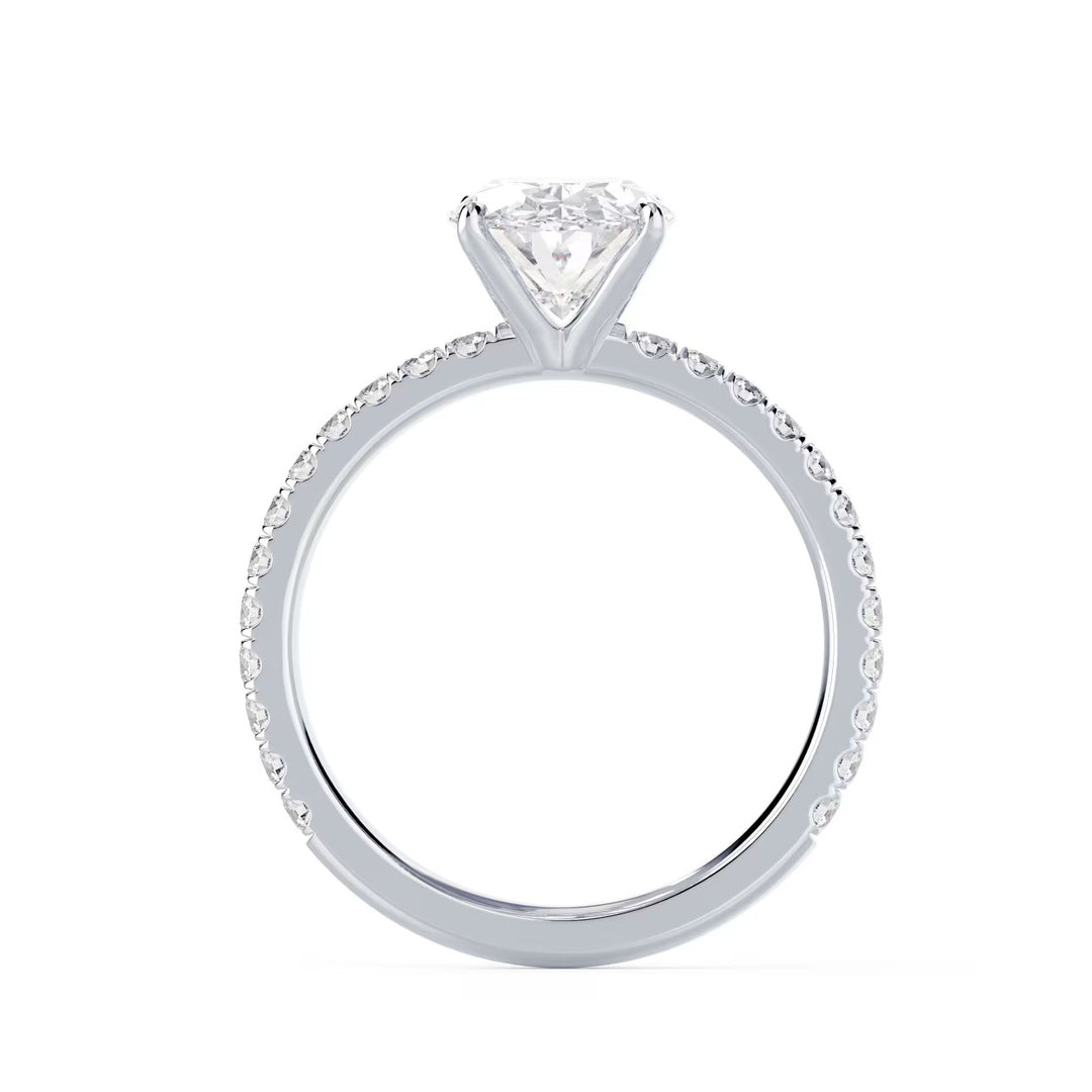 Close-up of an oval cut lab diamond pave engagement ring highlighting elongated brilliance and pavé band sparkle