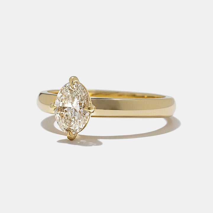 Close-up of oval cut lab grown diamond solitaire engagement ring showing clean prong setting and elegant symmetry