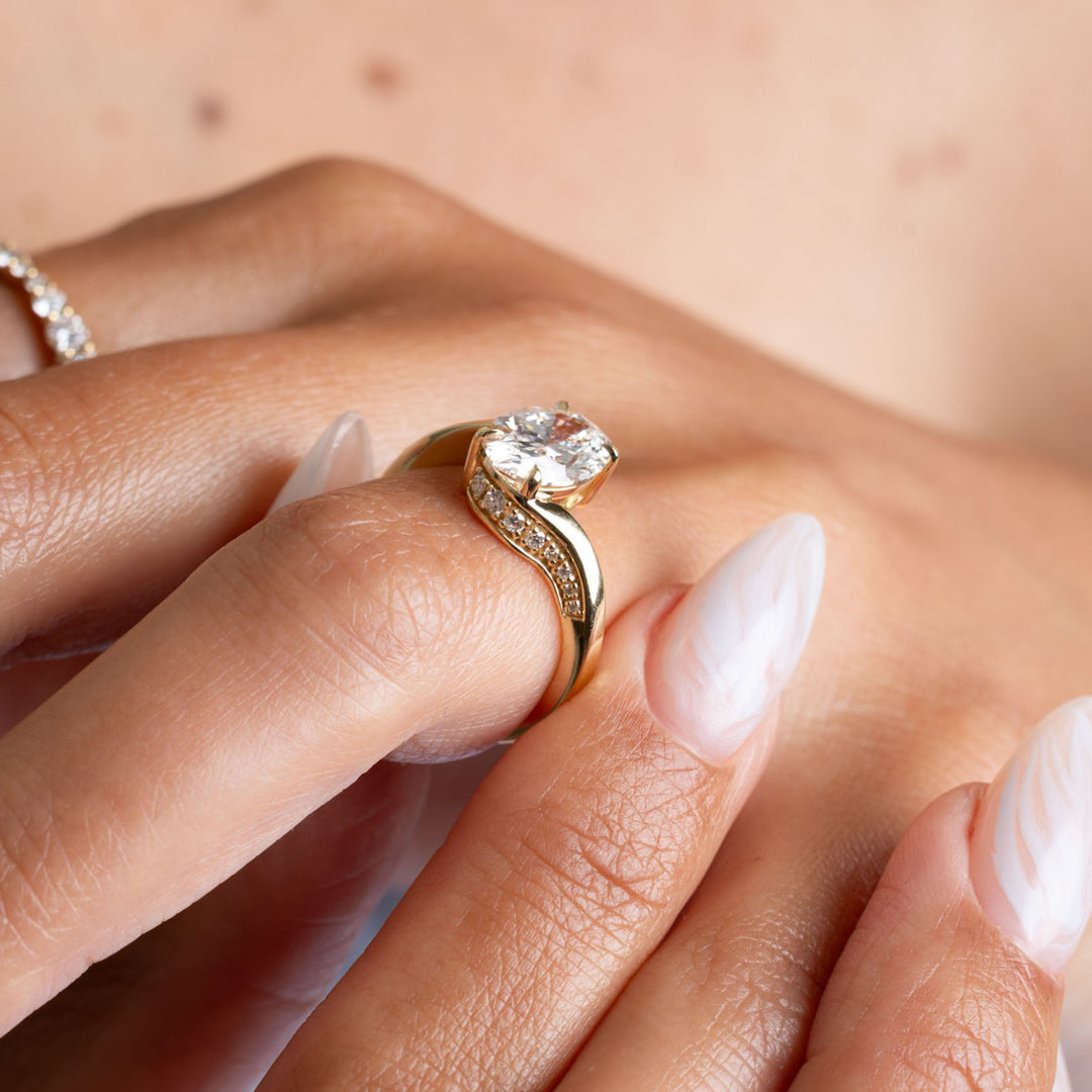 Top view of an oval cut lab grown diamond tension engagement ring showcasing open band structure and symmetry