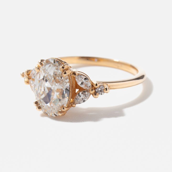 Side profile of oval lab diamond cluster engagement ring highlighting raised center stone and layered diamond structure