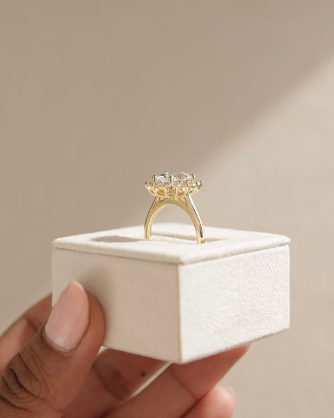 Detailed view of oval E VS1 lab grown diamond halo cathedral engagement ring showing clarity and halo symmetry