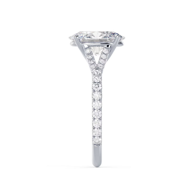 Side profile of an oval cut lab grown diamond split shank pave engagement ring showing open band structure