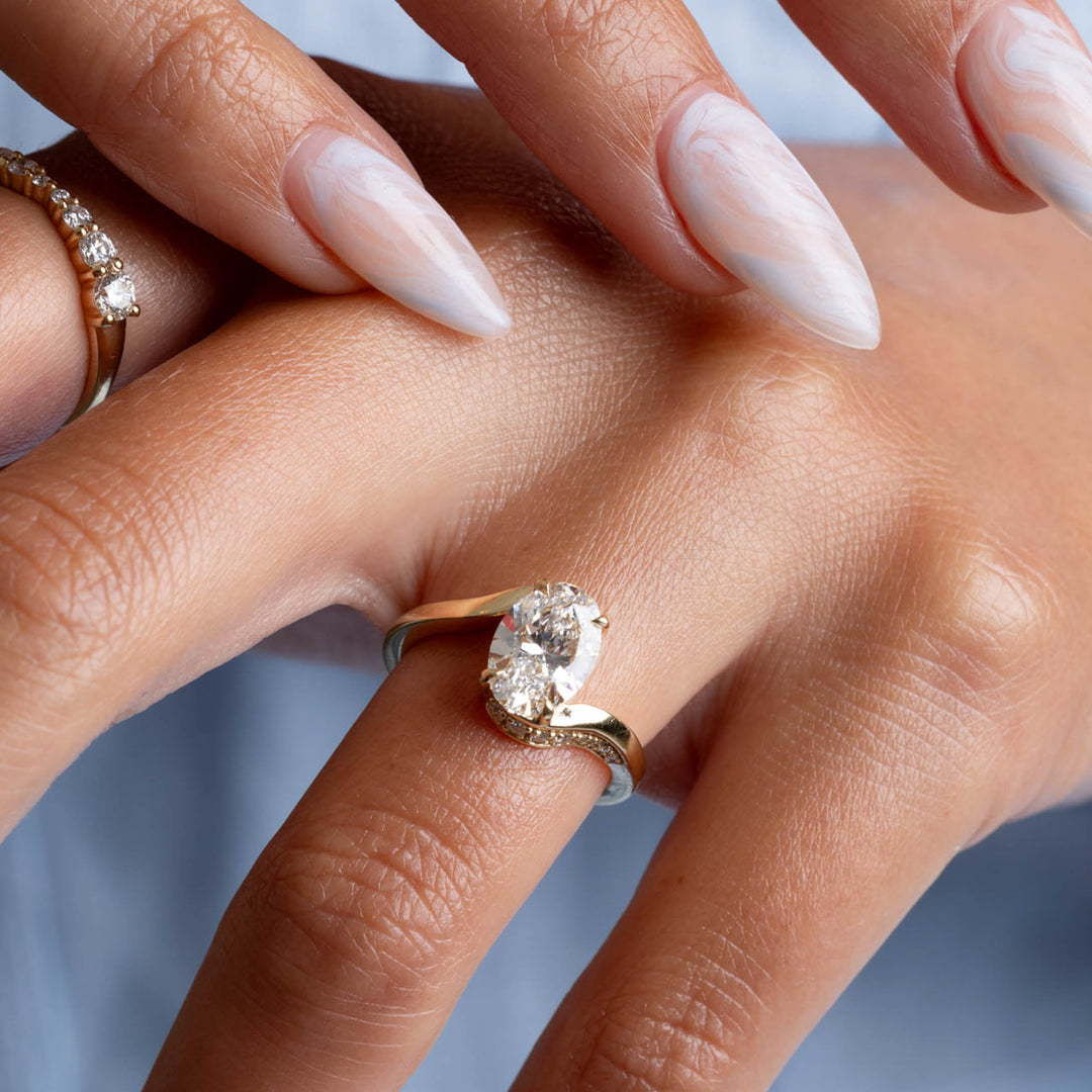 Lifestyle image of a 2 carat oval cut lab grown diamond tension engagement ring designed for modern minimal elegance