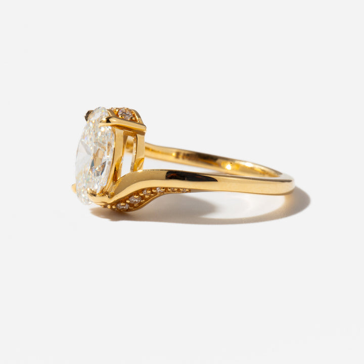 Side profile of a 2 carat oval cut lab grown diamond tension engagement ring showing secure pressure set design