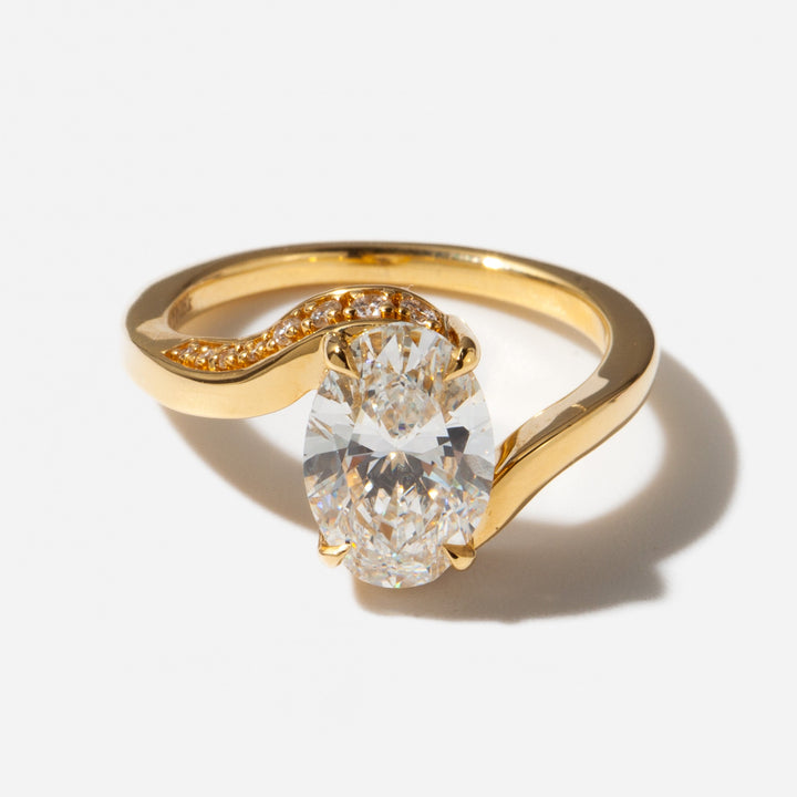 Close-up of an oval cut lab grown diamond tension engagement ring showing floating diamond effect and modern structure