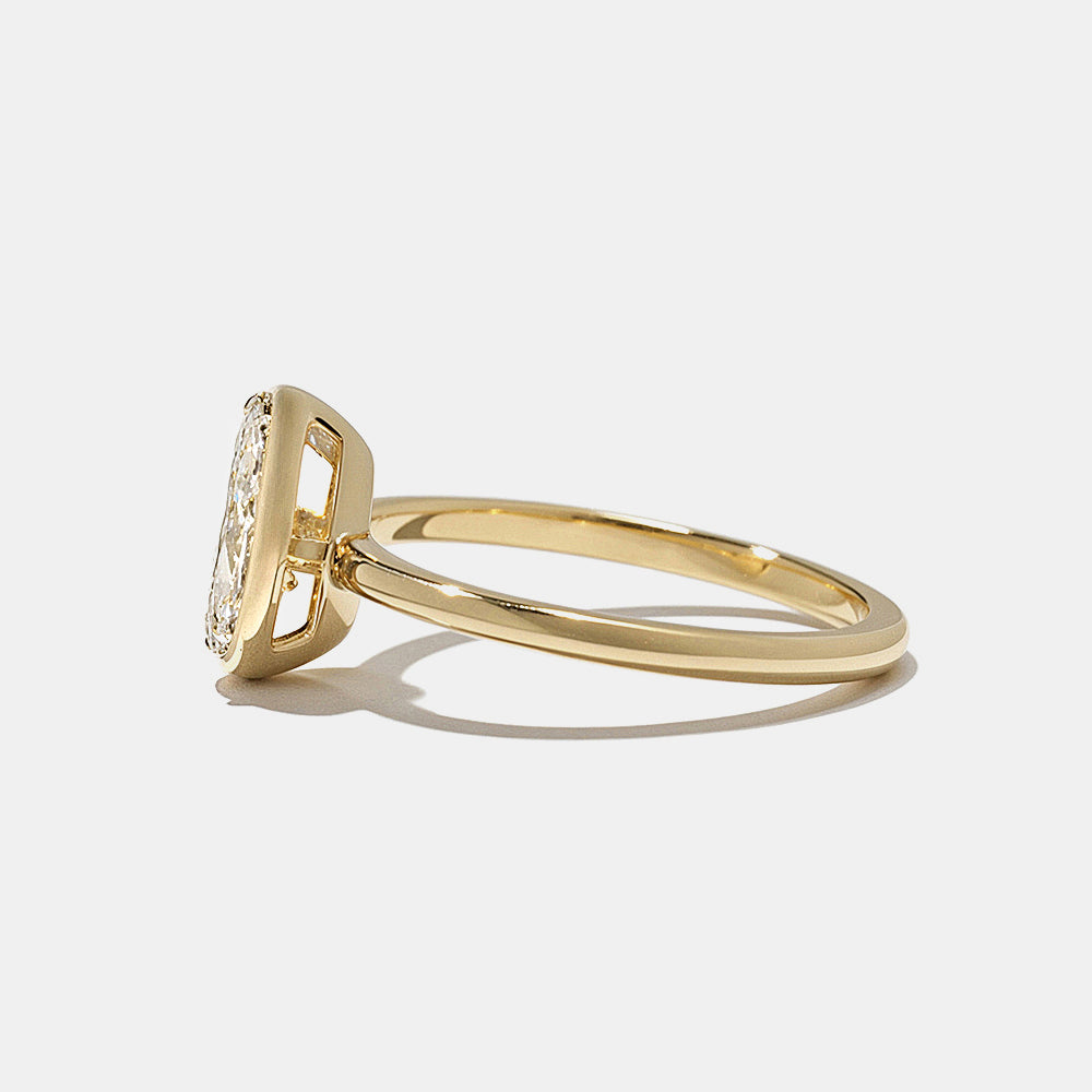 Close-up of pear lab grown diamond bezel engagement ring showing secure bezel frame and elegant teardrop shape