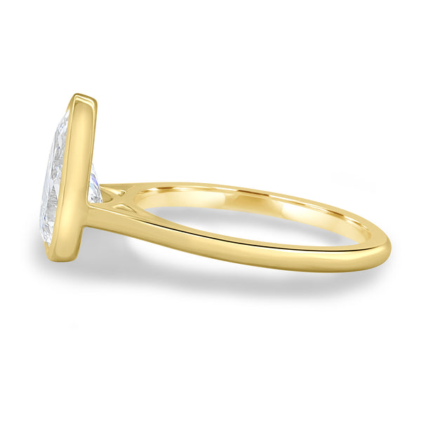 Side profile of bezel set pear lab grown diamond engagement ring showing cathedral arches and elevated center stone
