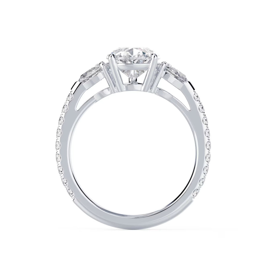 Close-up of a pear cut lab grown diamond three stone pave engagement ring highlighting brilliance and fine detailing