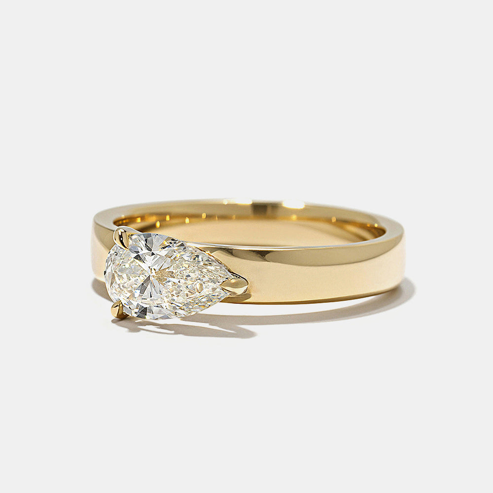 Side profile of pear east west lab diamond cigar band solitaire engagement ring highlighting bold band and sleek modern design