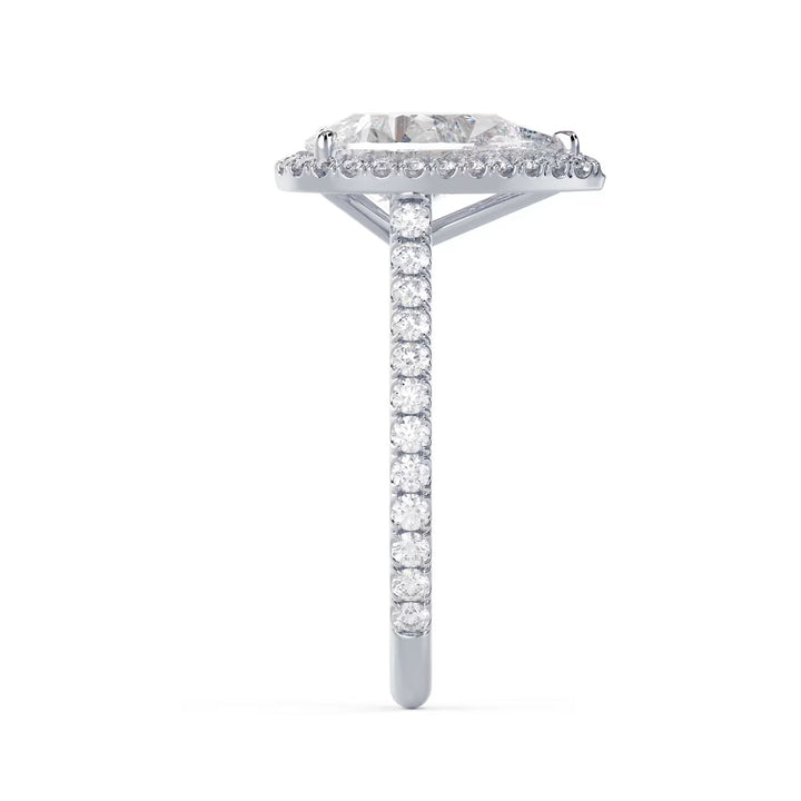 Side profile of a pear cut lab grown diamond halo cathedral pave engagement ring showing raised cathedral setting