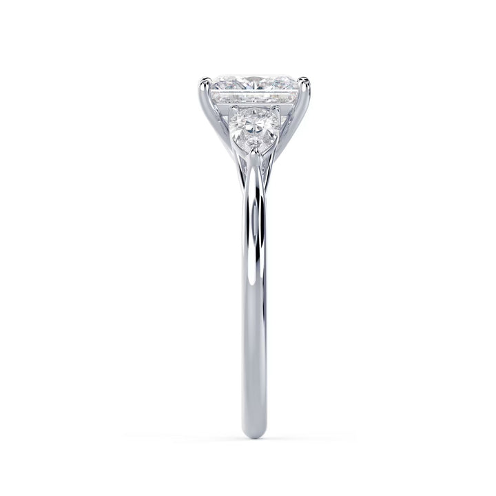 Close-up sparkle of princess cut lab grown diamond three stone engagement ring with E VS2 clarity and sharp brilliance