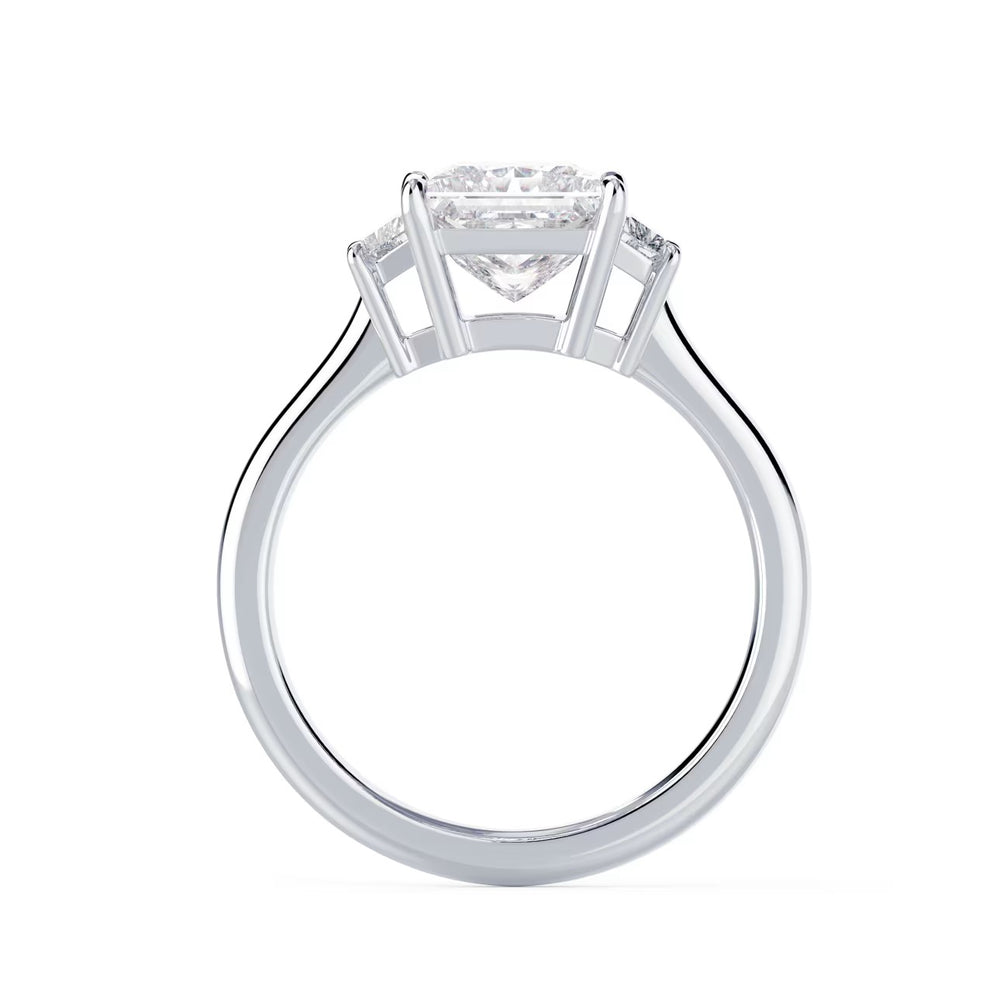 Close-up sparkle of princess cut lab grown diamond three stone engagement ring with E VS2 clarity and sharp brilliance