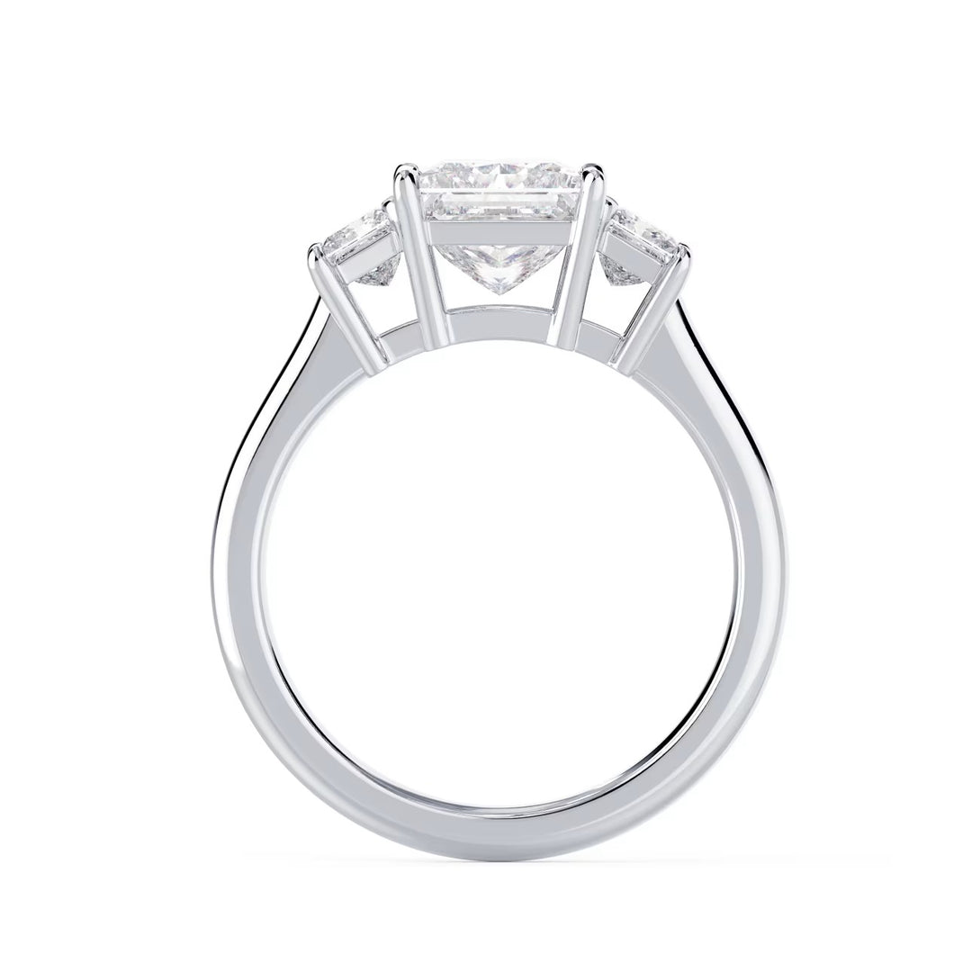 Close-up sparkle of princess cut lab grown diamond three stone solitaire engagement ring with sharp brilliance
