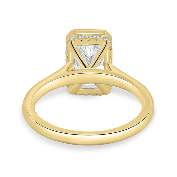 Close-up of radiant cut lab grown diamond hidden halo engagement ring showcasing secure bezel setting and concealed halo sparkle