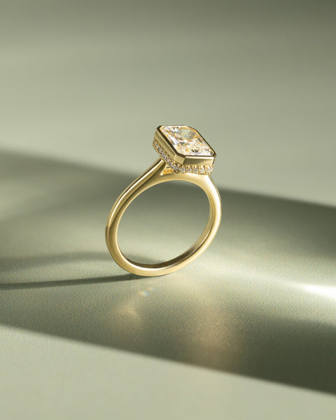 Detailed view of bezel set radiant lab grown diamond engagement ring showing hidden halo craftsmanship and brilliant facets