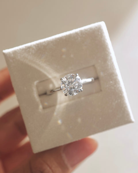 Round brilliant lab diamond engagement ring featuring a hidden halo and classic solitaire presentation
