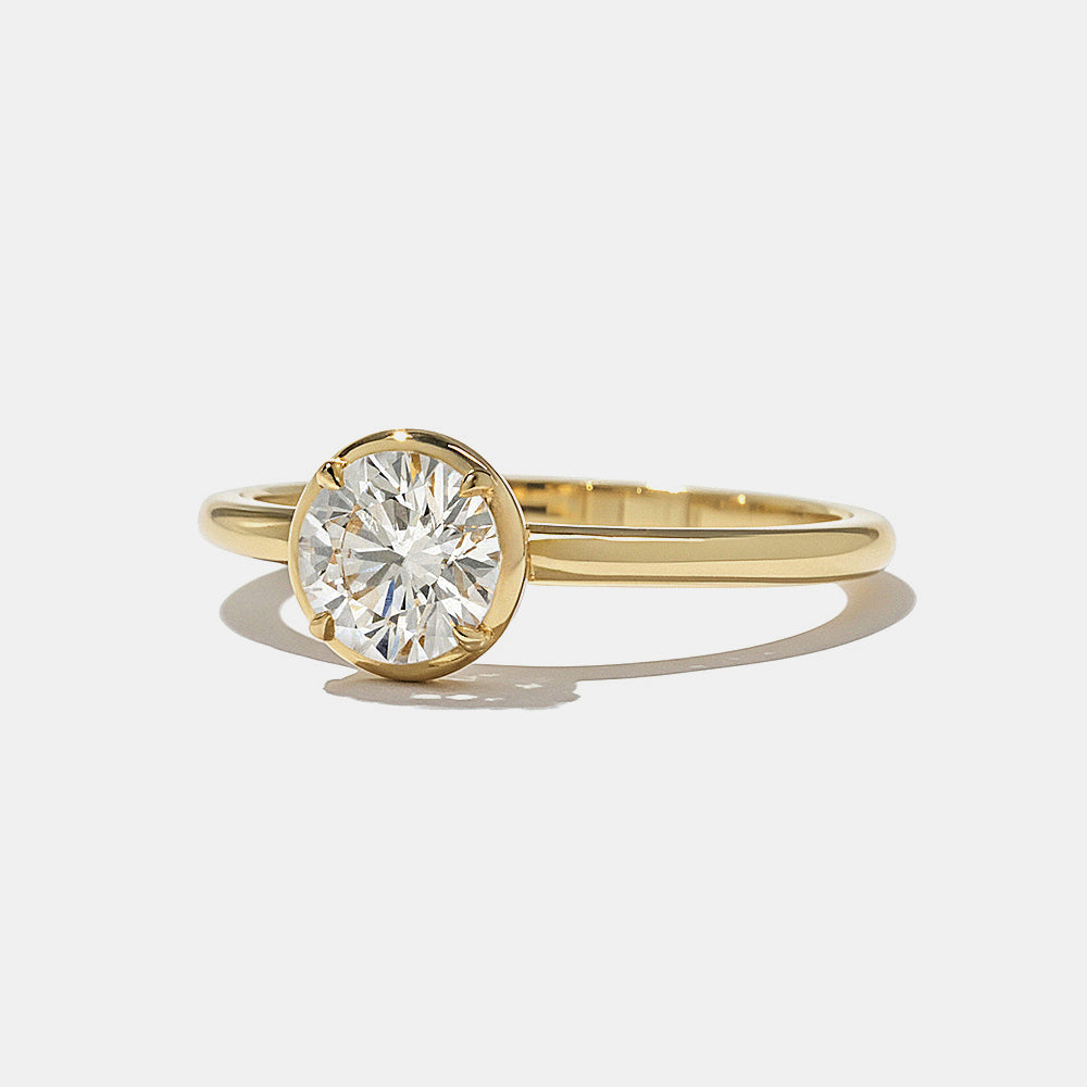 Close-up of round lab grown diamond bezel engagement ring showing secure metal frame and clean minimalist design